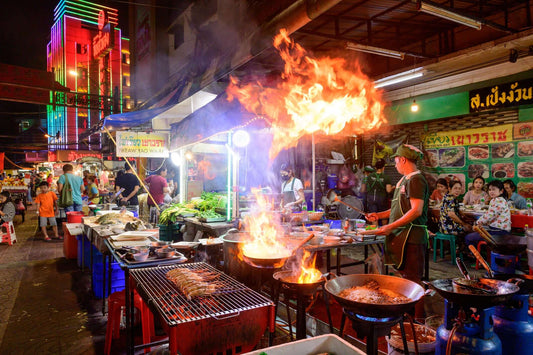 Vibrant Bangkok night market scene with street food vendors and colorful neon lights.