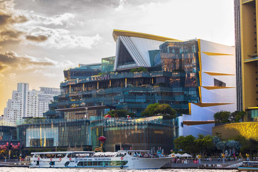 Siam Paragon Mall in Bangkok, showcasing modern architecture and luxury retail options by the water.
